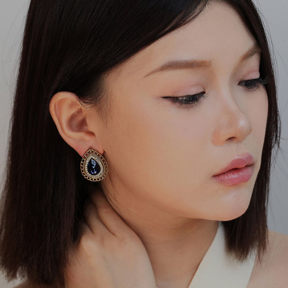 brown and blue earring